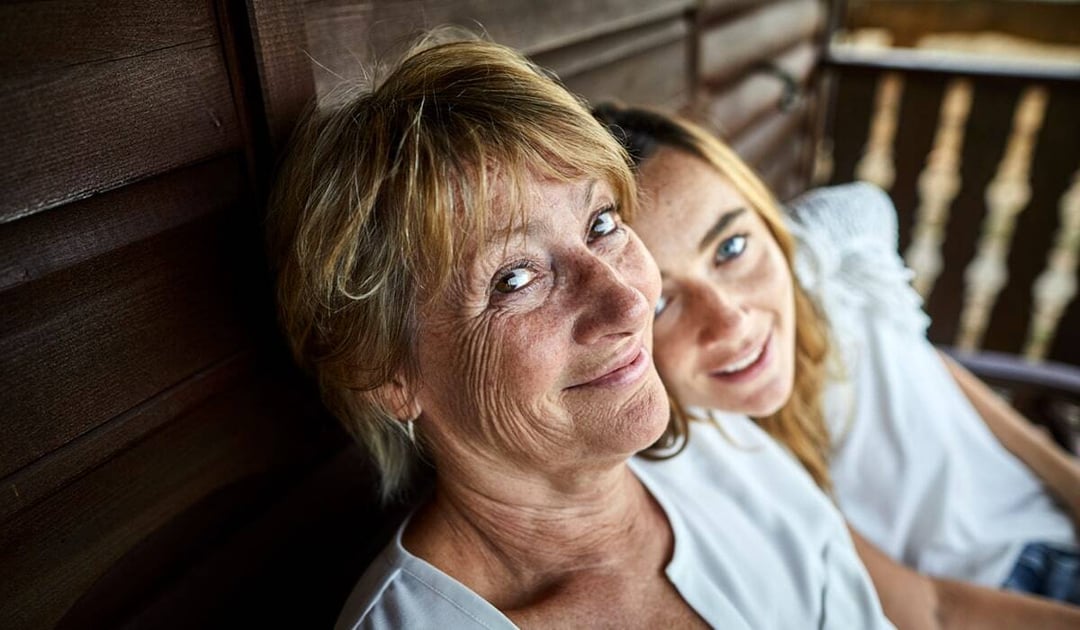 Mother an teenage granddaughter sitting outside