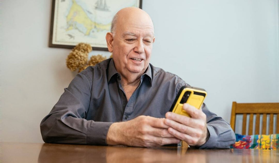 White man looking at his smartphone