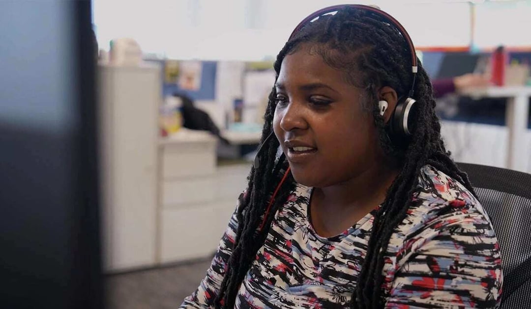 Young black women wearing a headset in an office