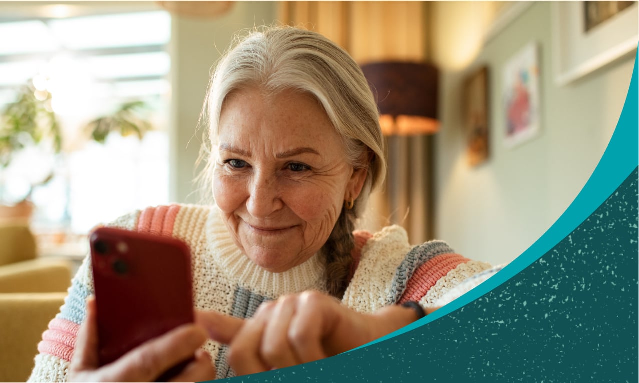 Older woman at home texting on a smartphone